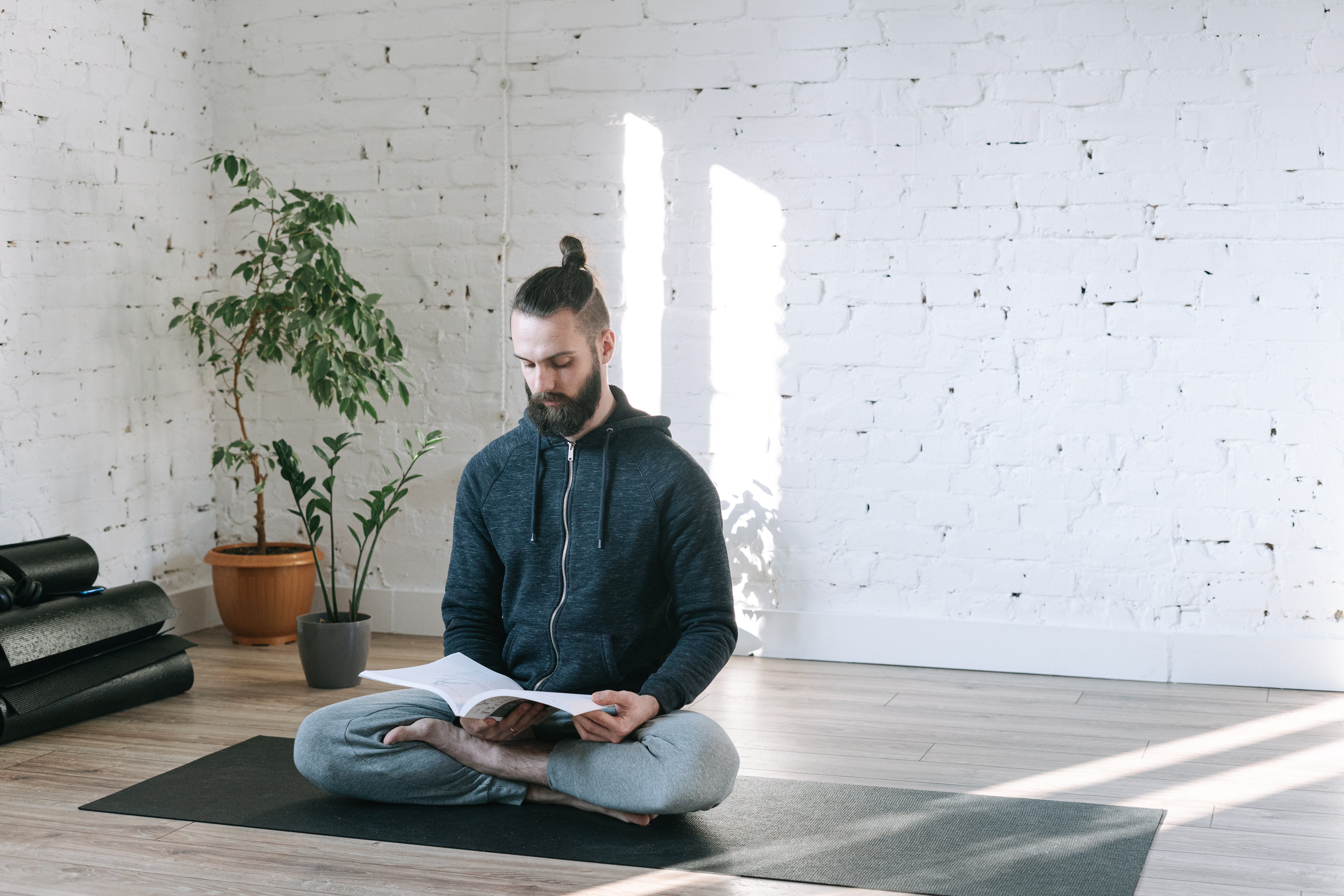 man studying on yoga mat