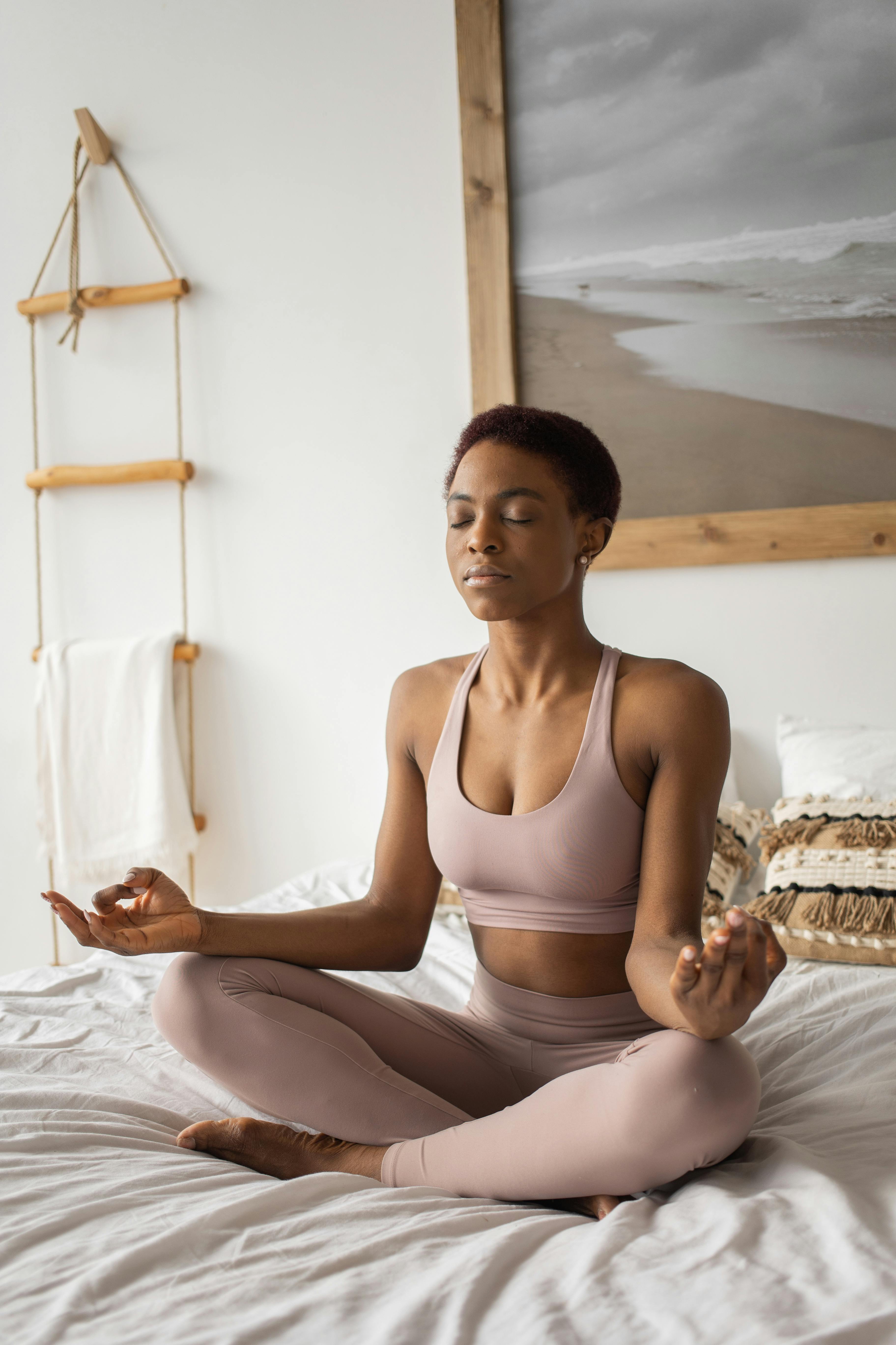 A woman meditating in bed